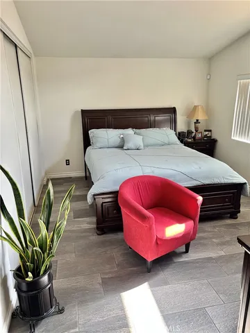 a bedroom with furniture and a potted plant