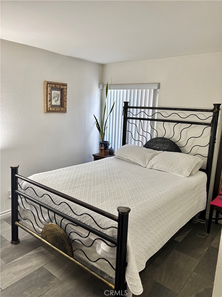 2830-2830 Chuckwagon Road Palmdale, CA 93550 - Photo 7 of 11 a bedroom with a bed and a table