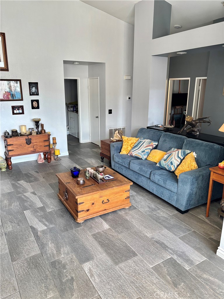 2830-2830 Chuckwagon Road Palmdale, CA 93550 - Photo 8 of 11 a living room with furniture and a flat screen tv