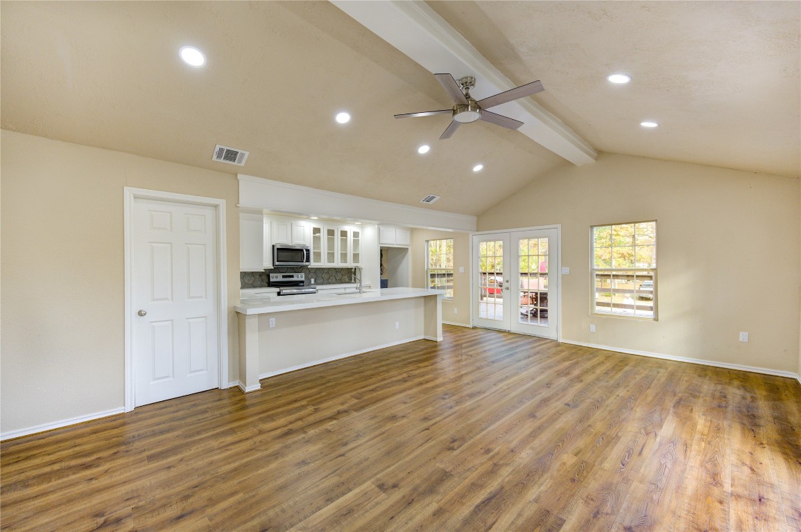235 6th Street Trinity, TX 75862 - Photo 1 of 29 a view of an empty room and kitchen with wooden floor