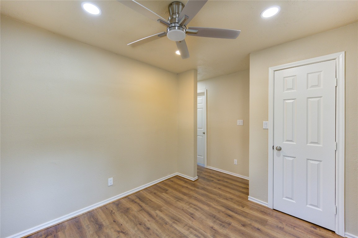 235 6th Street Trinity, TX 75862 - Photo 14 of 29 an empty room with wooden floor and a ceiling fan