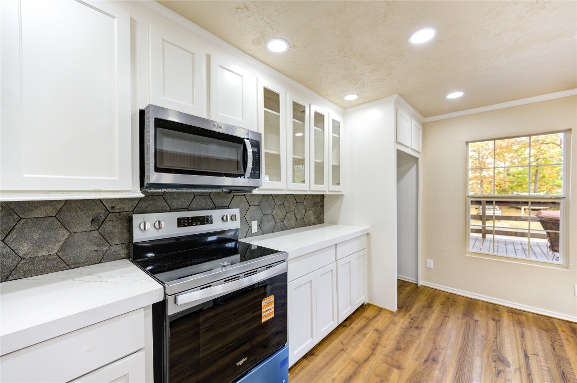 235 6th Street Trinity, TX 75862 - Photo 6 of 29 a kitchen with a stove and a microwave