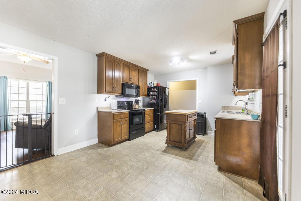104 Weatherwood Road Kathleen, GA 31047 - Photo 12 of 35 a kitchen with a refrigerator and a stove top oven