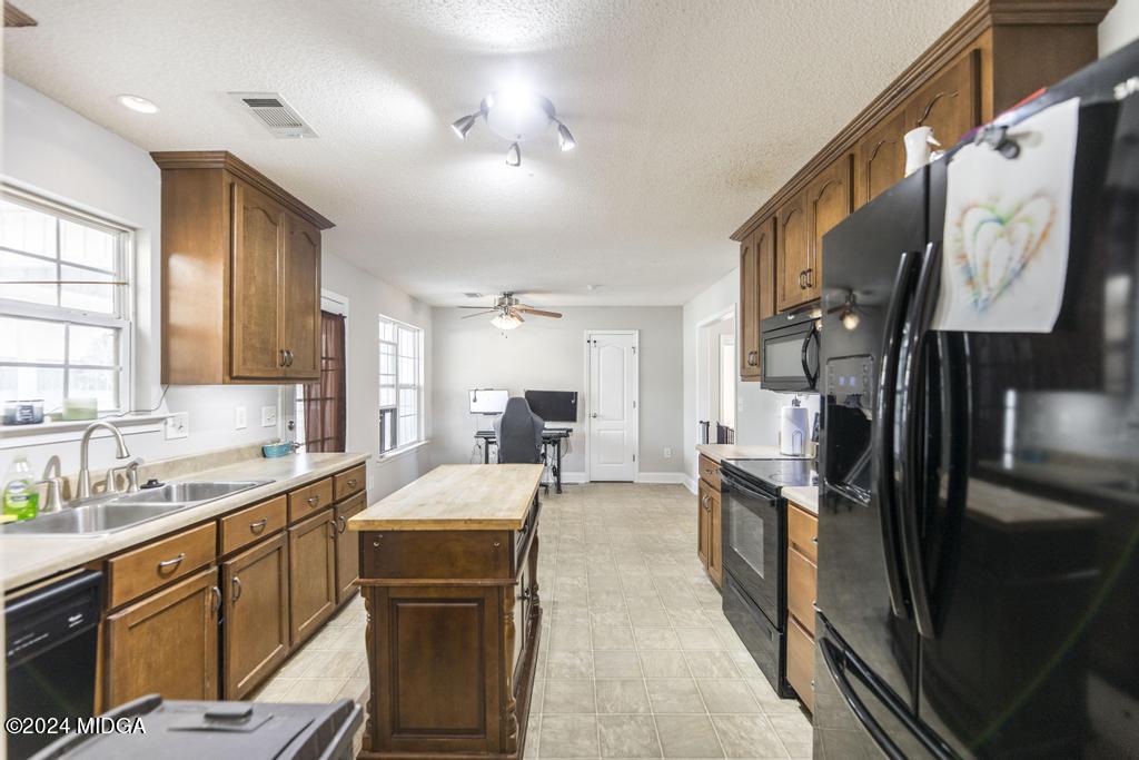 104 Weatherwood Road Kathleen, GA 31047 - Photo 15 of 35 a large kitchen with a large window cabinets stainless steel appliances and a counter top space