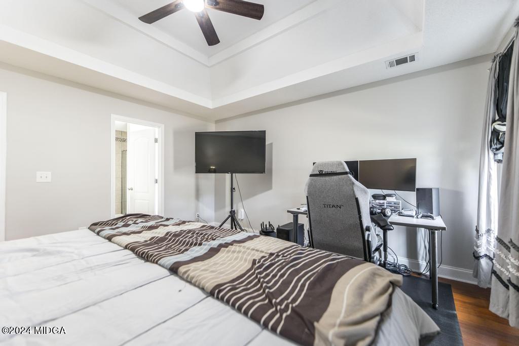 104 Weatherwood Road Kathleen, GA 31047 - Photo 18 of 35 a bedroom with a bed and a flat screen tv