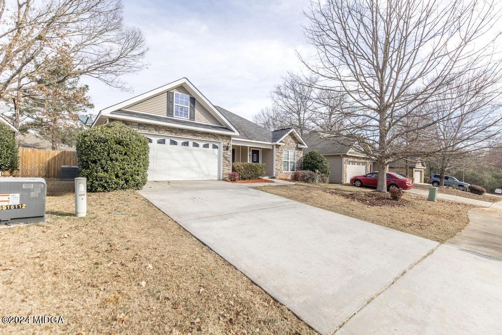 104 Weatherwood Road Kathleen, GA 31047 - Photo 2 of 35 a house with trees in front of it