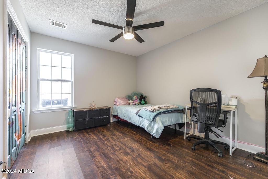 104 Weatherwood Road Kathleen, GA 31047 - Photo 27 of 35 a spacious bedroom with a bed and a window