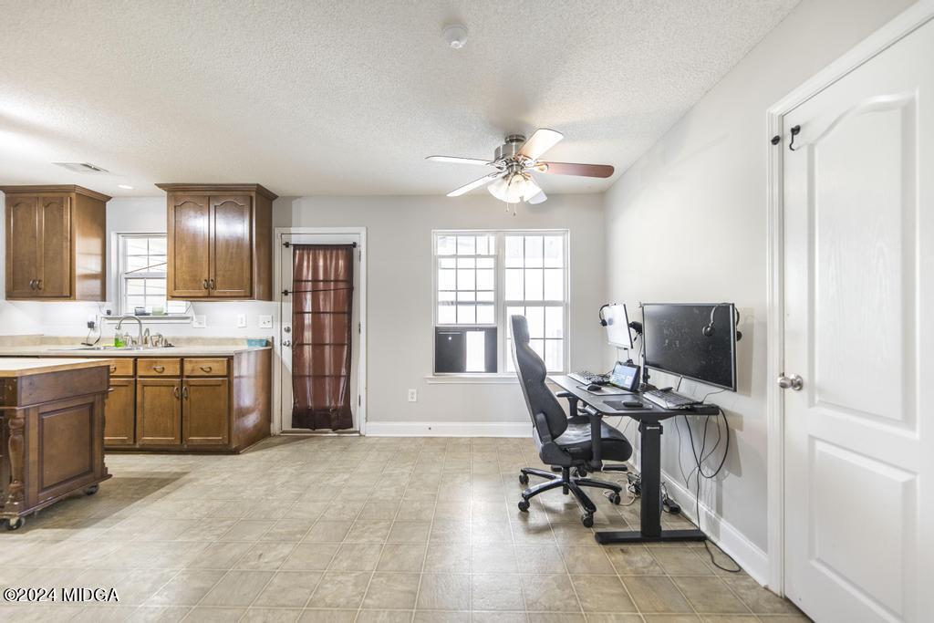 104 Weatherwood Road Kathleen, GA 31047 - Photo 10 of 35 a view of a workspace with furniture and a window