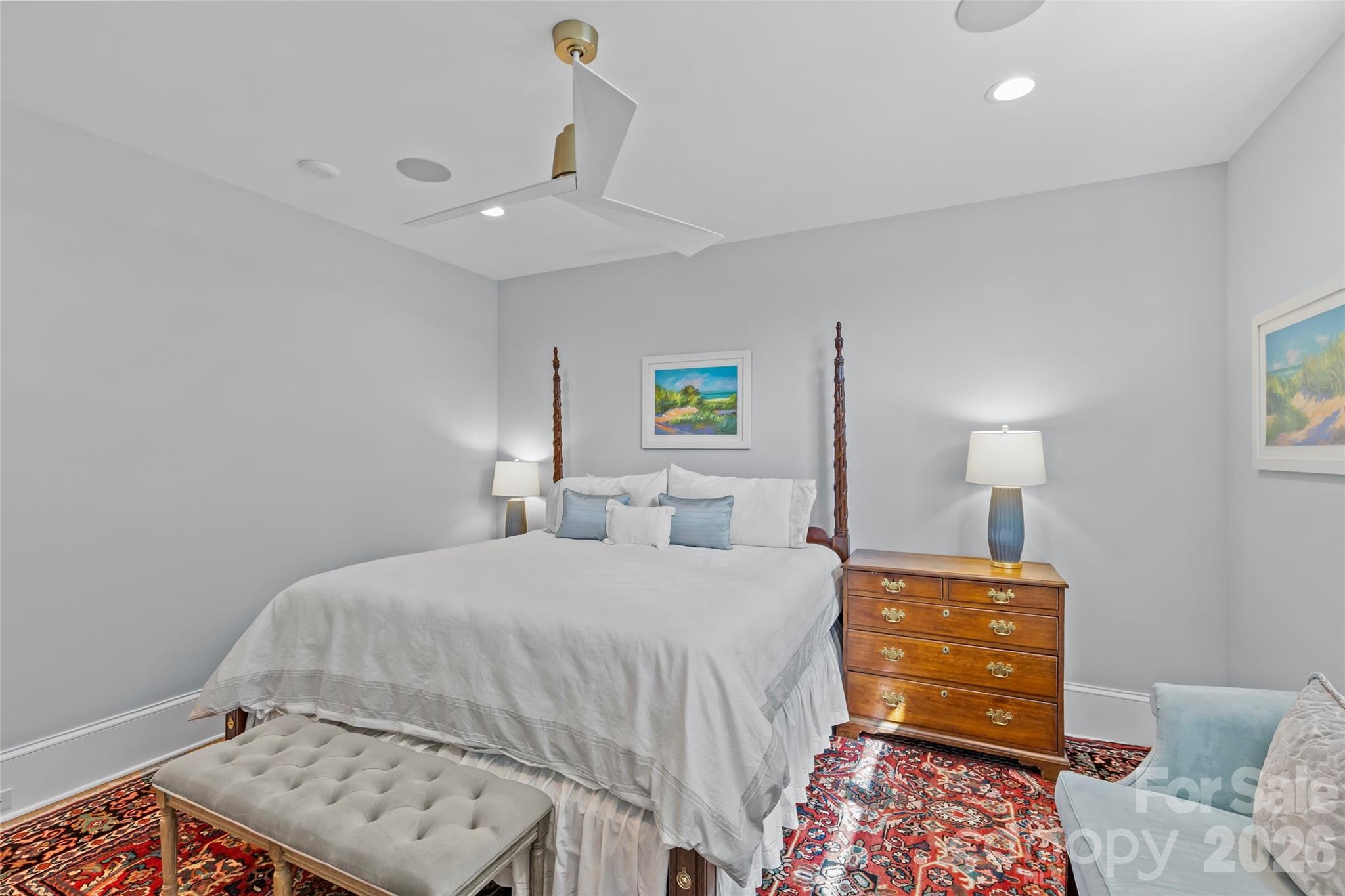 1500 Queens Road, Unit 104 Charlotte, NC 28207 - Photo 26 of 41 a bedroom with a bed and a lamp with the dresser