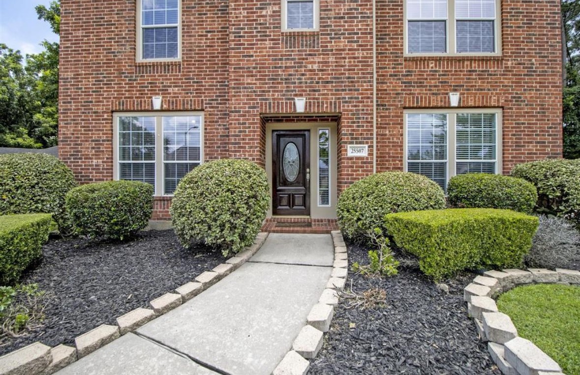 a front view of a house with garden