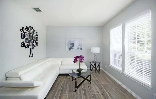 a living room with furniture and a large window
