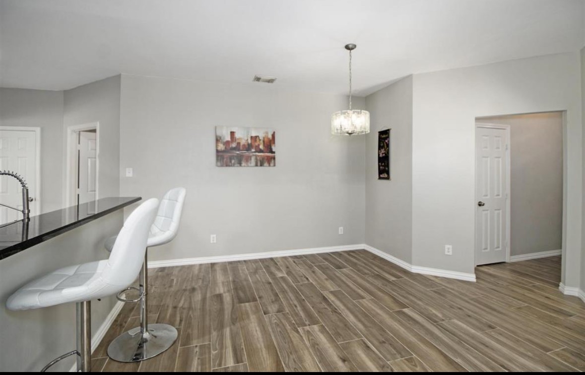 25507 Lyon Springs Court Spring, TX 77373 - Photo 6 of 9 a view of a room with wooden floor and furniture