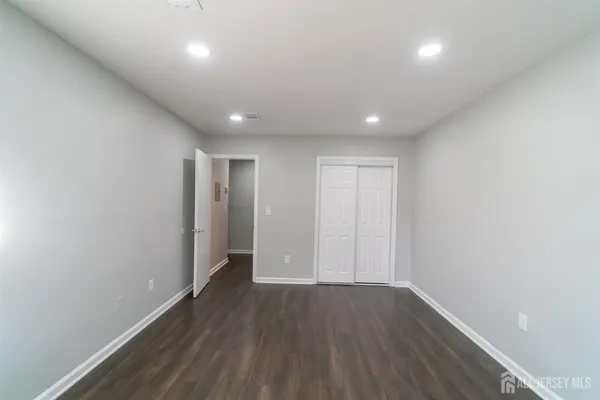 a view of hallway with wooden floor