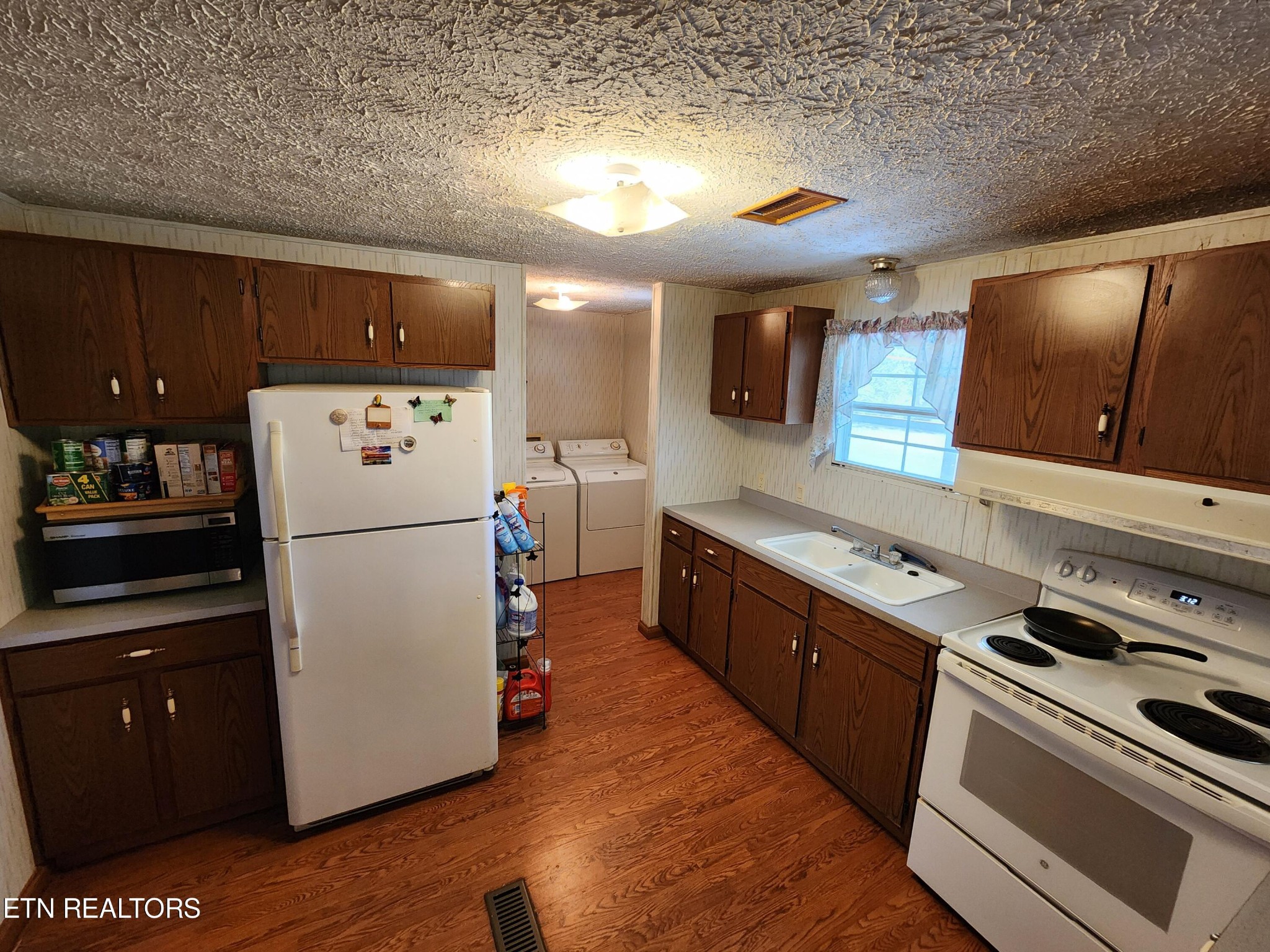 199 Carson Pugh Road Crossville, TN 38571 - Photo 43 of 58 a kitchen with refrigerator and cabinets
