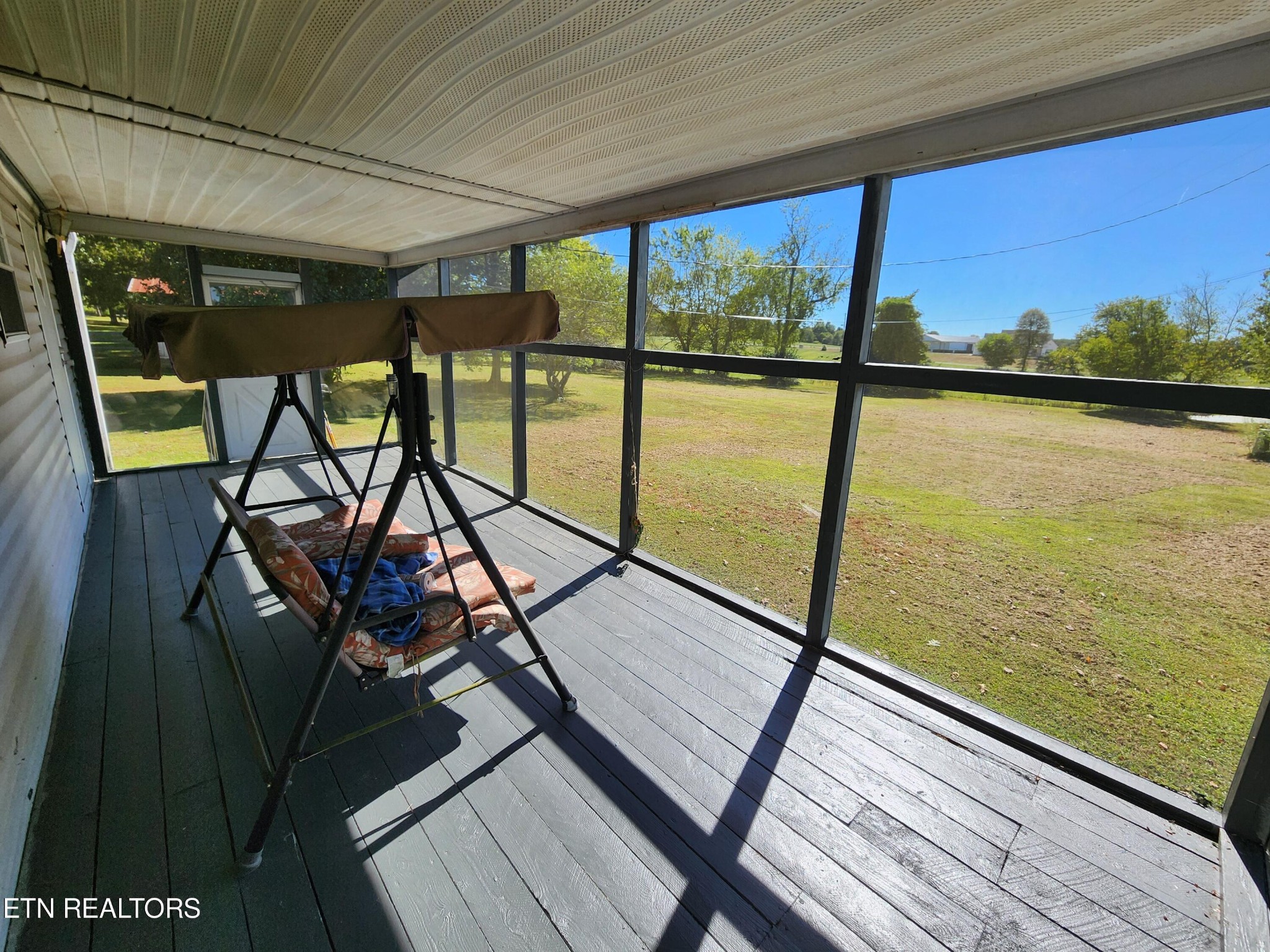 199 Carson Pugh Road Crossville, TN 38571 - Photo 46 of 58 a view of a balcony with chairs and wooden floor