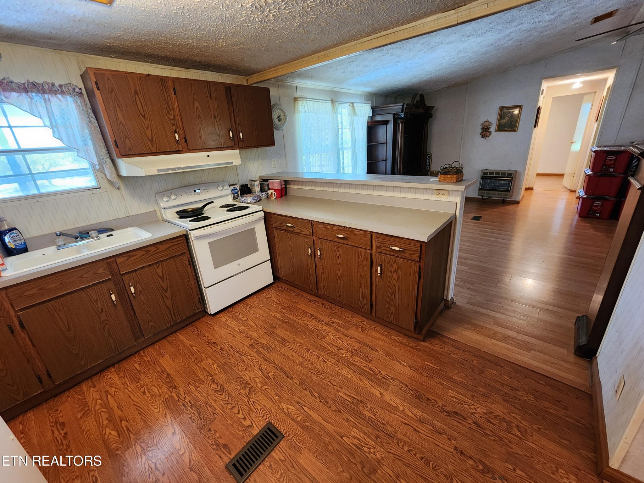 199 Carson Pugh Road Crossville, TN 38571 - Photo 48 of 58 a kitchen with stainless steel appliances granite countertop a sink counter space and wooden floor
