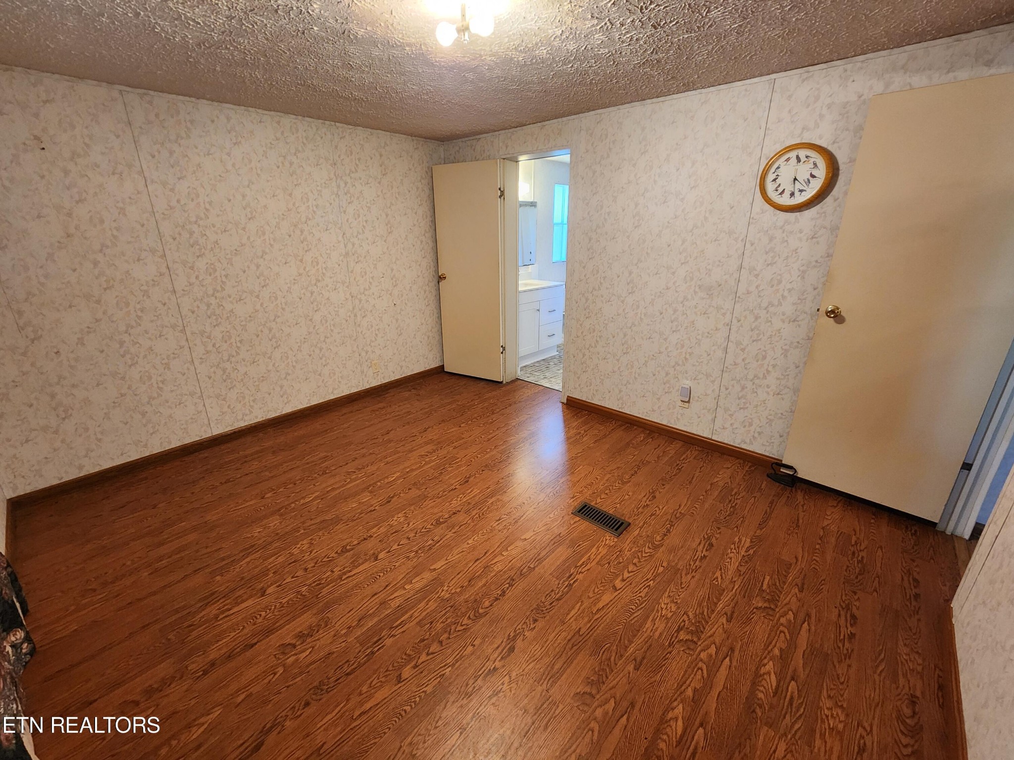 199 Carson Pugh Road Crossville, TN 38571 - Photo 51 of 58 a view of an empty room with wooden floor and a window
