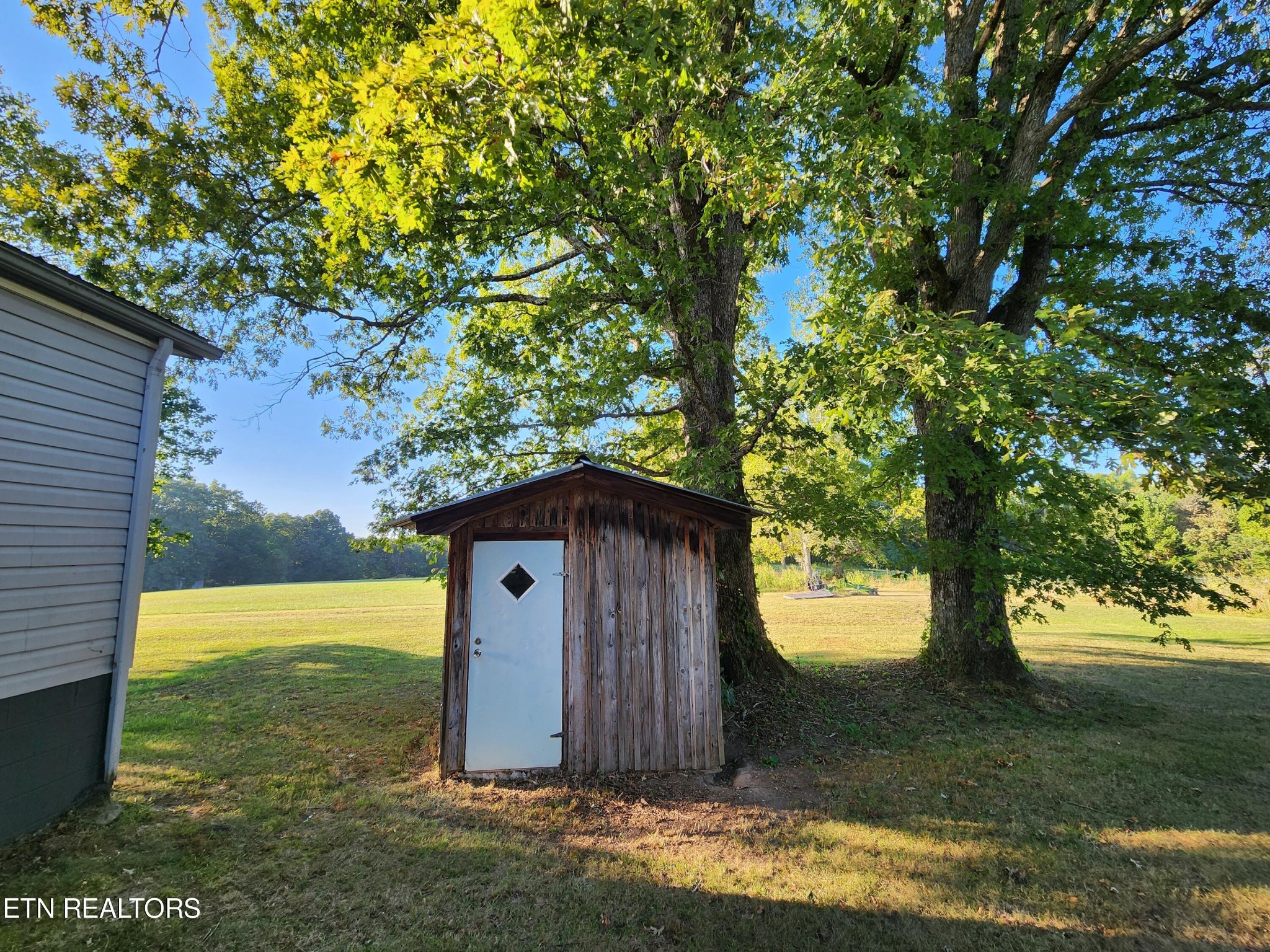 199 Carson Pugh Road Crossville, TN 38571 - Photo 7 of 58 a view of a barn in the middle of a yard