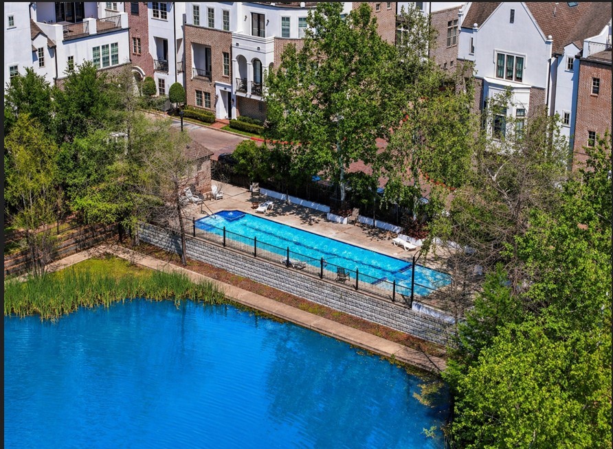 9427 London Bridge Station Houston, TX 77045 - Photo 1 of 30 Discover a serene residential oasis featuring elegant, well-maintained homes with a communal pool, nestled amid lush greenery and beside a tranquil pond, offering a peaceful and picturesque retreat for potential buyers.