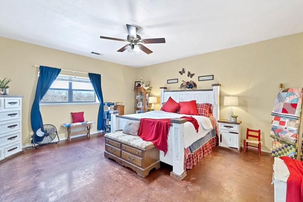 7709 Fm 902 Sherman, TX 75092 - Photo 12 of 39 a bedroom with a bed and a chandelier