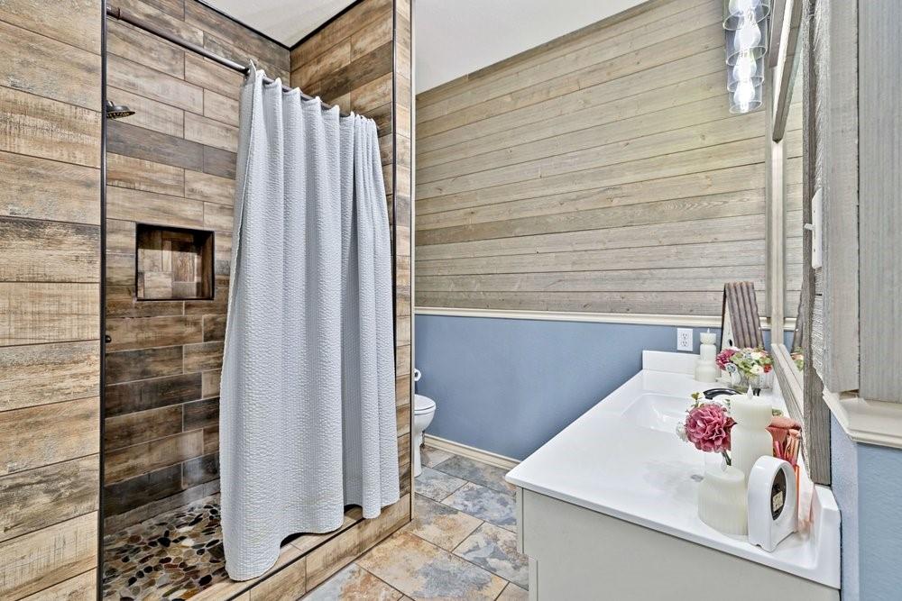 7709 Fm 902 Sherman, TX 75092 - Photo 14 of 39 a bathroom with a sink and a shower