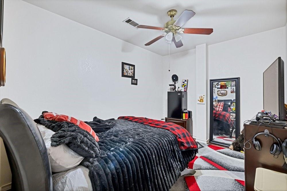 7709 Fm 902 Sherman, TX 75092 - Photo 20 of 39 a bedroom that has a bed and a chandelier