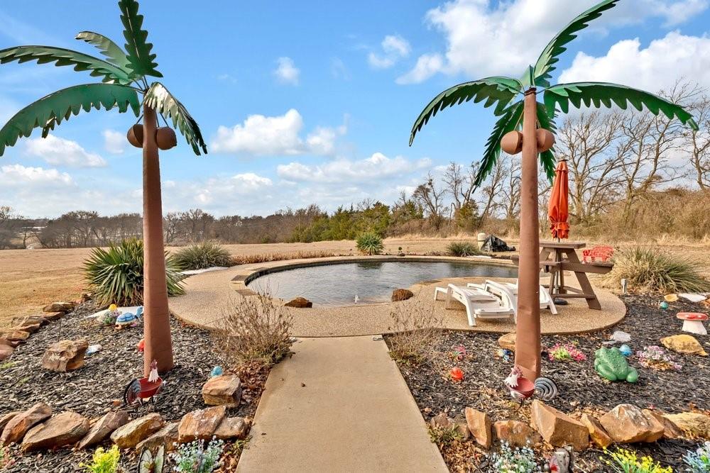 7709 Fm 902 Sherman, TX 75092 - Photo 2 of 39 a view of a lake with a palm tree