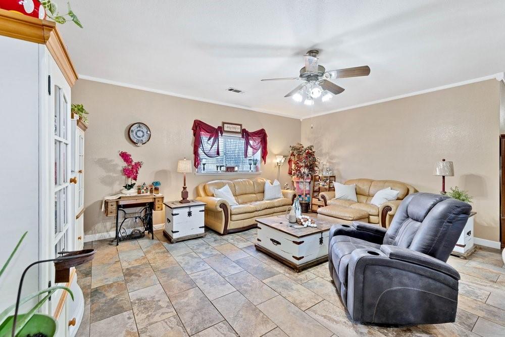 7709 Fm 902 Sherman, TX 75092 - Photo 7 of 39 a living room with furniture flowerpot and a chandelier