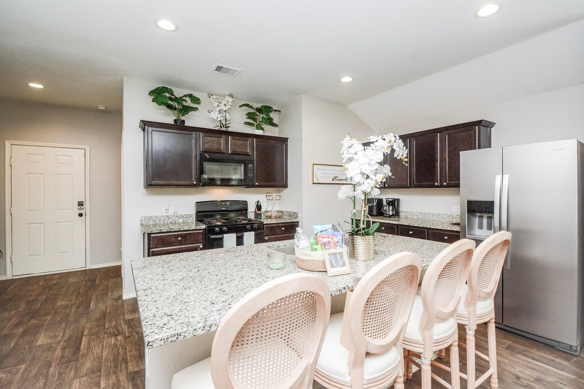 23510 Harrow Fld Lane Spring, TX 77373 - Photo 5 of 18 a kitchen with granite countertop stainless steel appliances a stove refrigerator a sink dishwasher with a dining table and chairs