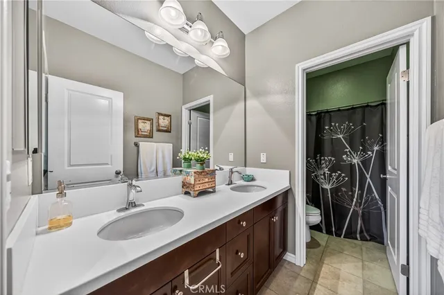 a bathroom with a sink double vanity and a mirror