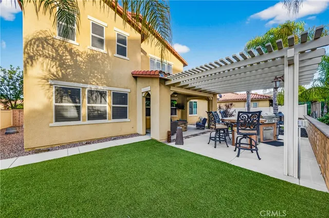 a view of a patio with table and chairs and potted plants
