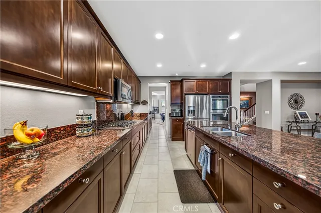 a kitchen with stainless steel appliances granite countertop counter space a sink and cabinets