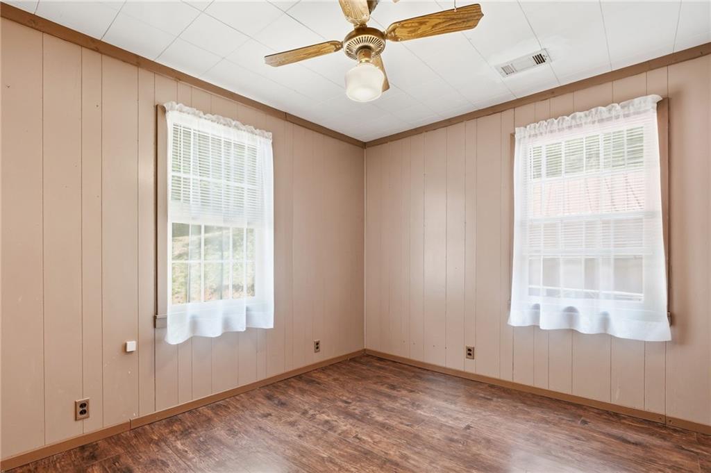 1709 Harrington Road Ball Ground, GA 30107 - Photo 20 of 46 an empty room with windows and fan