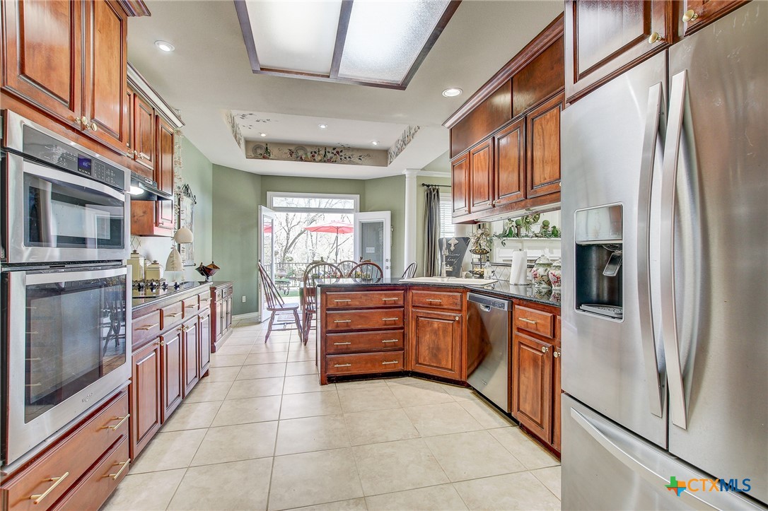 200 Carriage House Road Salado, TX 76571 - Photo 13 of 43 a kitchen with stainless steel appliances granite countertop a refrigerator a stove and a sink with cabinets