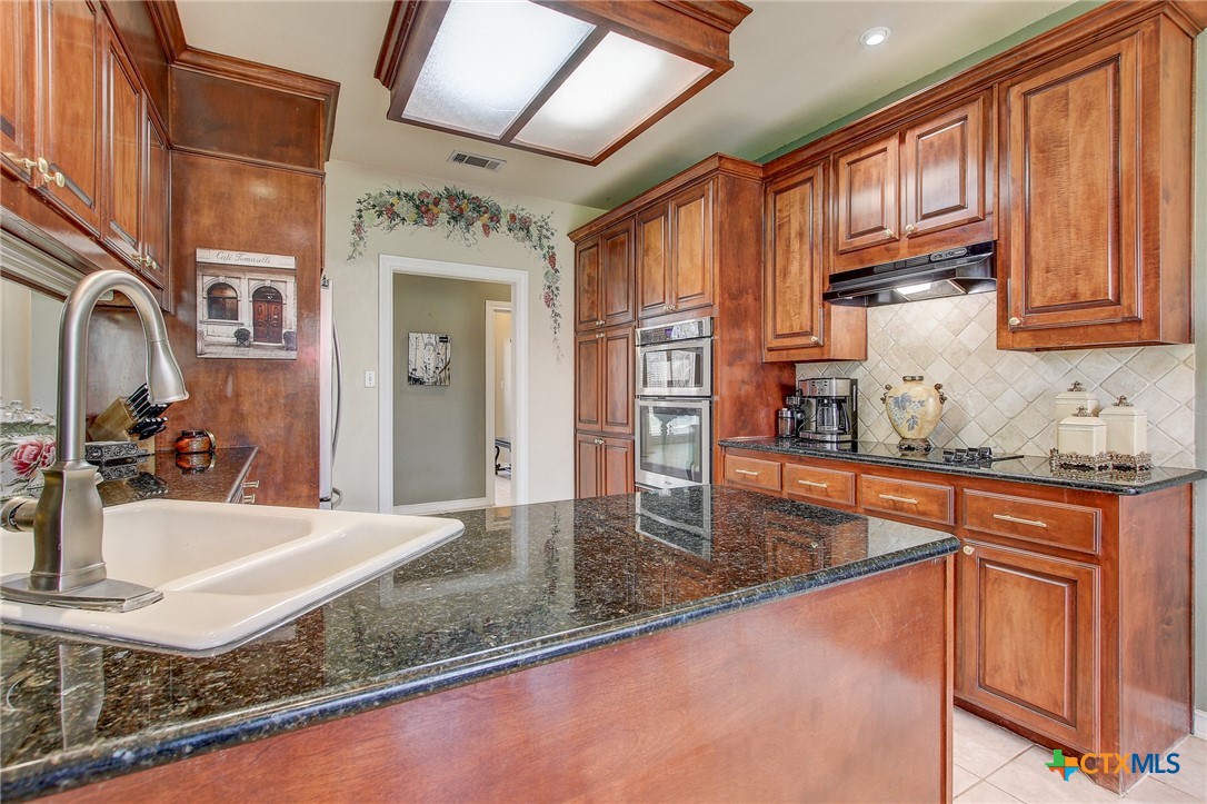 200 Carriage House Road Salado, TX 76571 - Photo 15 of 43 a kitchen with stainless steel appliances granite countertop a sink stove and cabinets