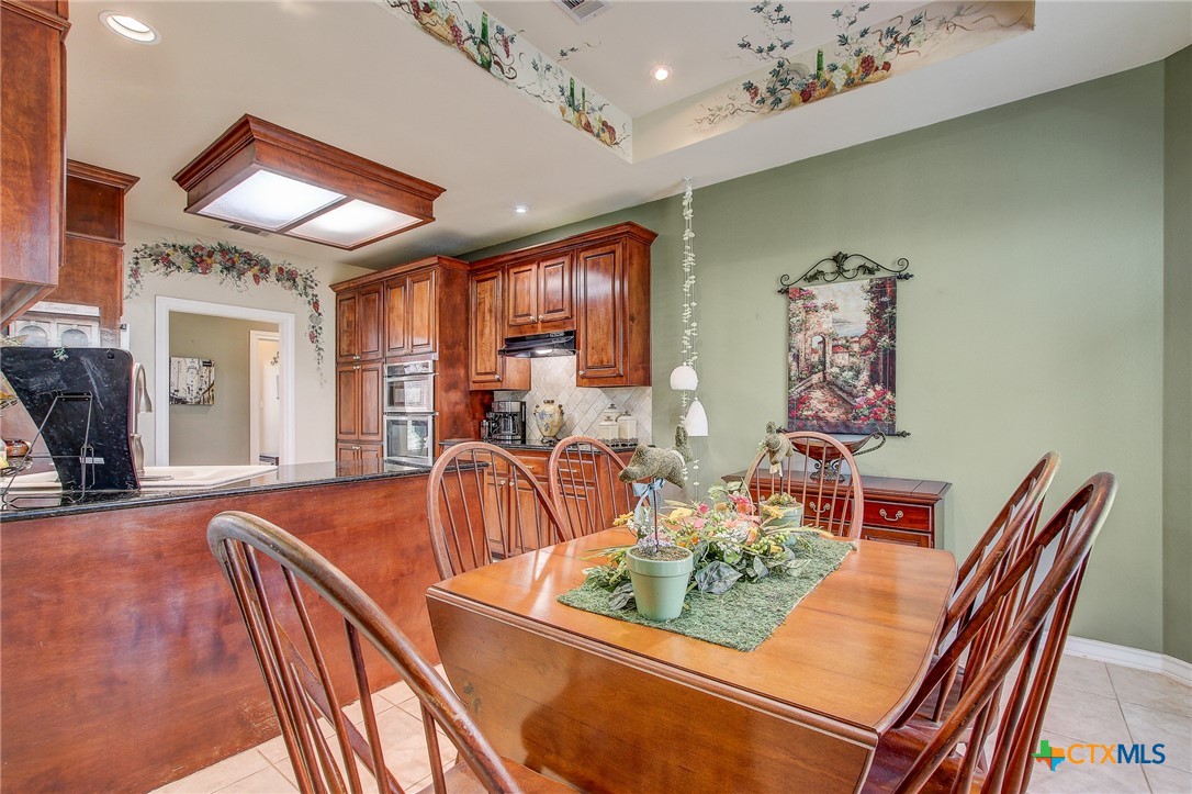 200 Carriage House Road Salado, TX 76571 - Photo 18 of 43 a view of a dining room with furniture a chandelier and wooden floor