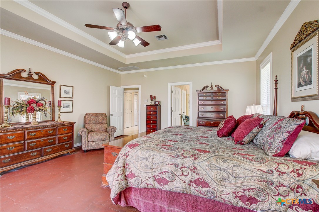 200 Carriage House Road Salado, TX 76571 - Photo 20 of 43 a bedroom with a bed and a chandelier