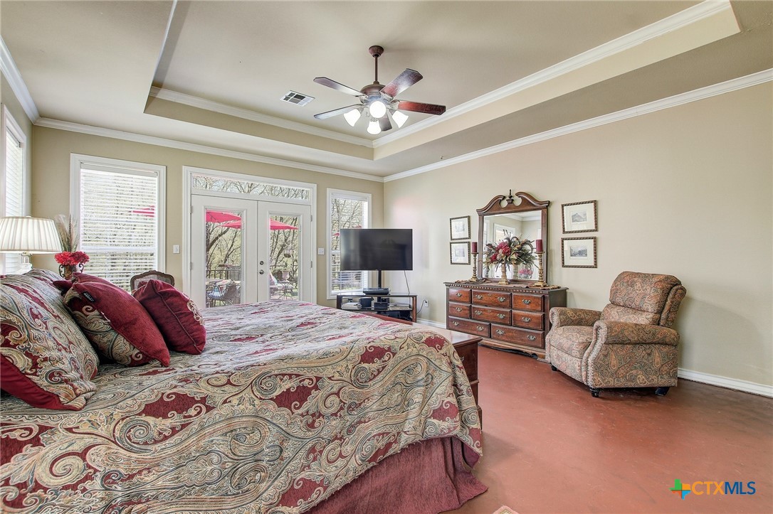 200 Carriage House Road Salado, TX 76571 - Photo 21 of 43 a bedroom with a bed couches and a flat screen tv