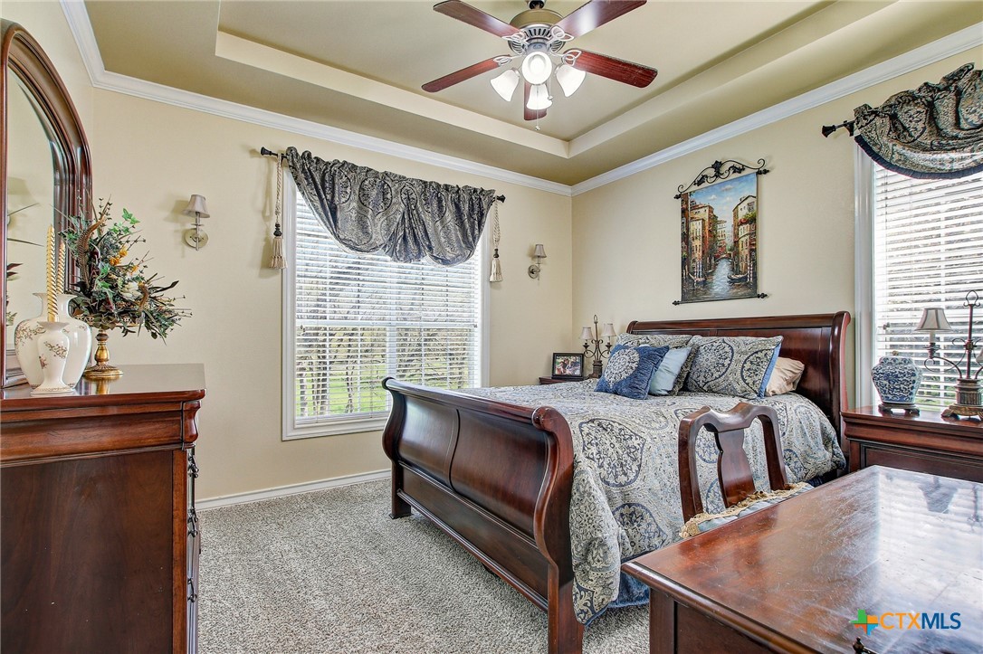 200 Carriage House Road Salado, TX 76571 - Photo 26 of 43 a bedroom with a bed and a chandelier