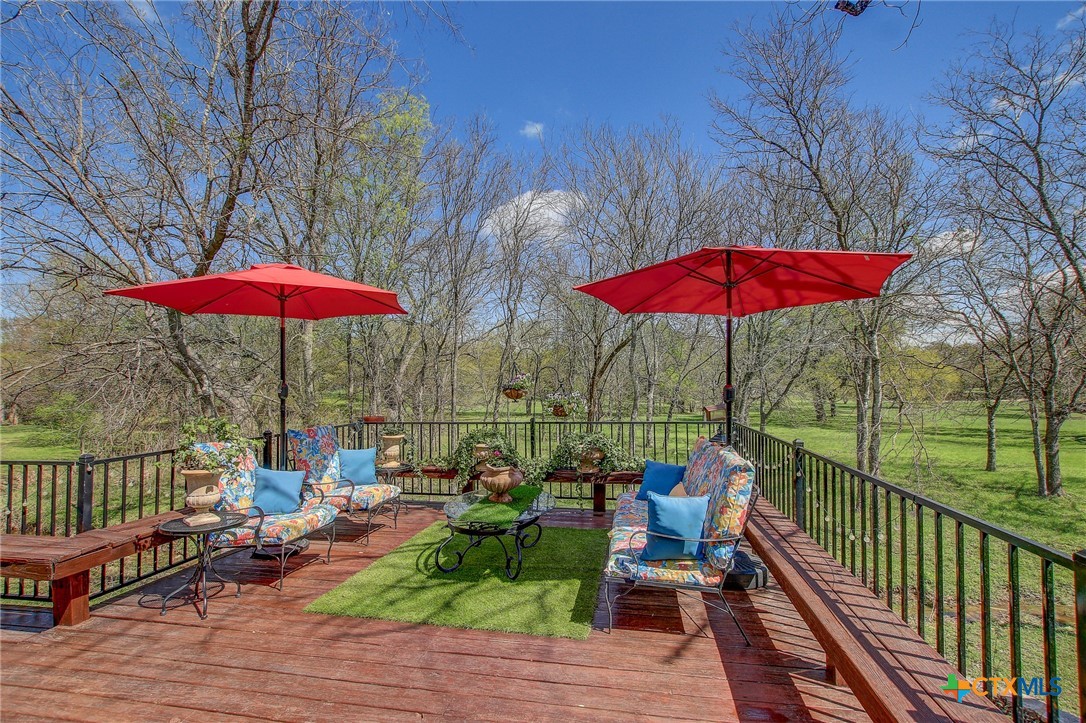 200 Carriage House Road Salado, TX 76571 - Photo 29 of 43 an outdoor sitting area with umbrella and wooden floor