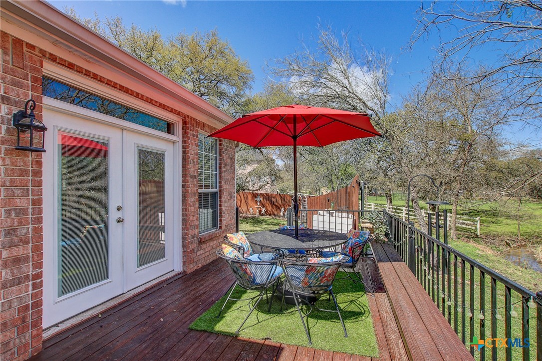 200 Carriage House Road Salado, TX 76571 - Photo 33 of 43 a view of balcony with chairs and umbrella