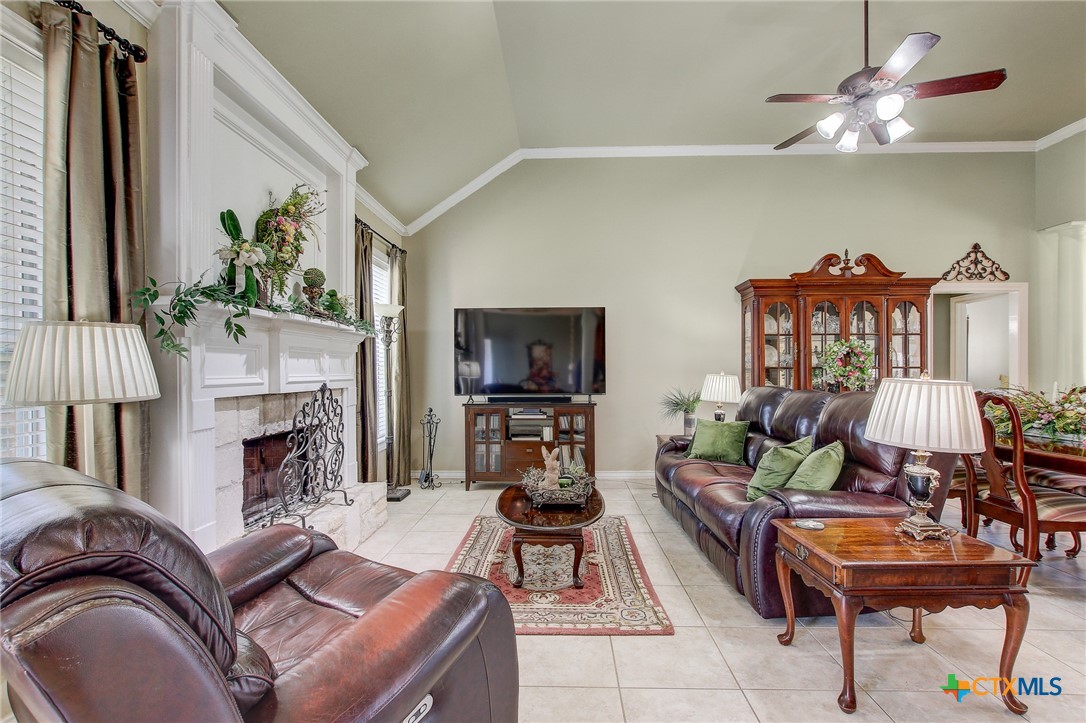 200 Carriage House Road Salado, TX 76571 - Photo 9 of 43 a living room with furniture a fireplace and a flat screen tv