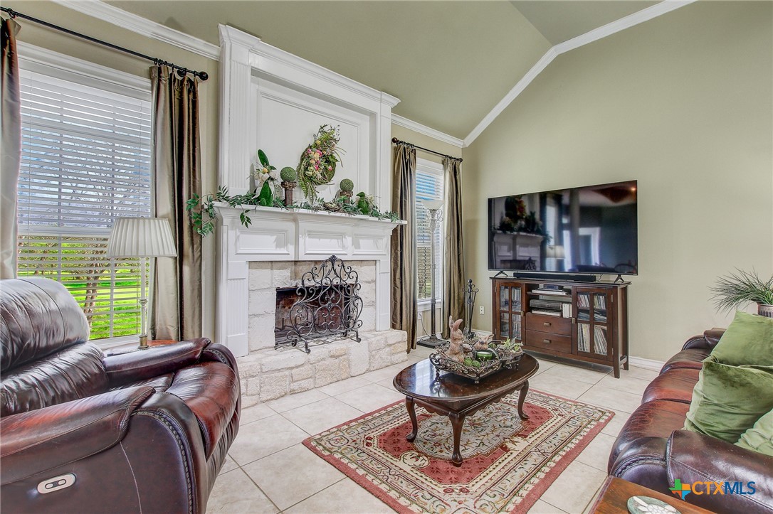 200 Carriage House Road Salado, TX 76571 - Photo 10 of 43 a living room with furniture a flat screen tv and a fireplace