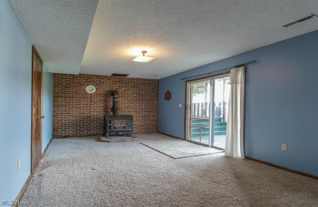 3618 Dayton Road Madison, OH 44057 - Photo 13 of 23 Recreation room in lower level with walk-out to covered patio.