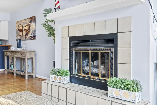 a living room with furniture a flat screen tv and a fireplace