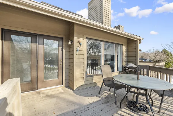 a bedroom with a bed and a dresser with wooden floor