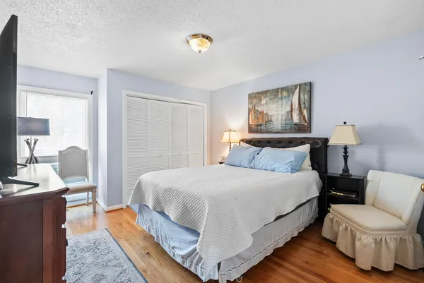 a living room with a bed furniture and kitchen view