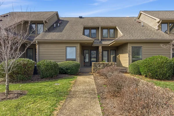 an aerial view of a house with swimming pool having outdoor seating