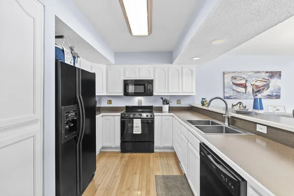 a kitchen with a refrigerator stove and sink
