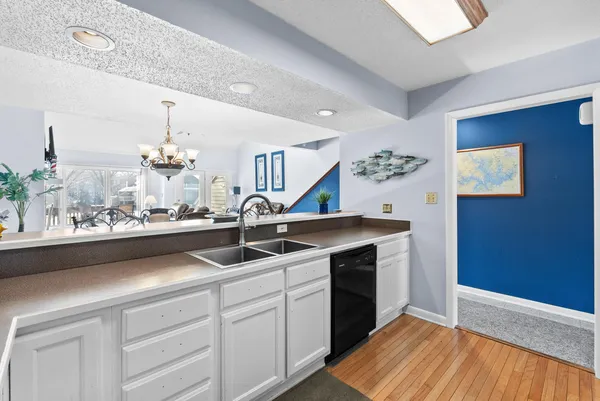 a kitchen with a sink and chandelier
